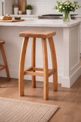 Bali solid oak bar stool at a kitchen island with square seat and curved legs, compact breakfast bar stool design