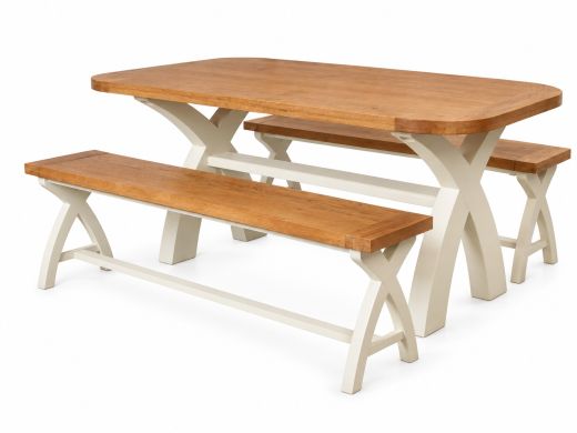 Country Oak 180cm cream painted rounded corner cross leg dining table with two matching 160cm benches in a country kitchen with white cabinets and terracotta flooring