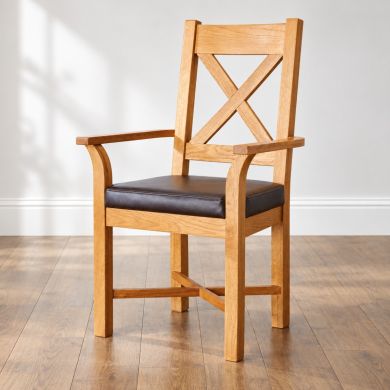 Grasmere solid oak carver dining chair with X-back design, curved armrests and brown leather seat