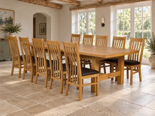 Chateaux solid oak extra large dining table fully extended to 340cm with 10 oak slat-back Chelsea chairs and black seat pads in a country-house dining room
