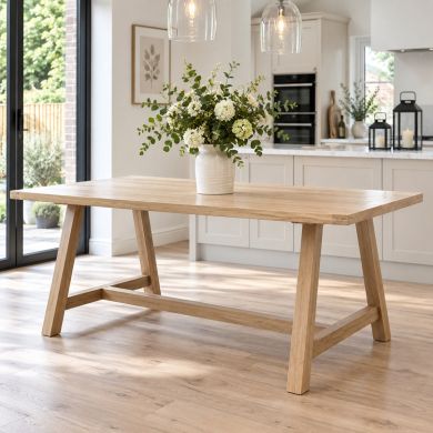 Doveridge 180cm whitewash limed oak trestle dining table in a bright contemporary kitchen setting