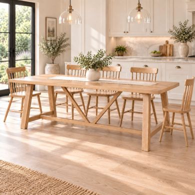 Doveridge 240cm whitewash limed oak large trestle dining table with spindleback chairs in a bright country kitchen