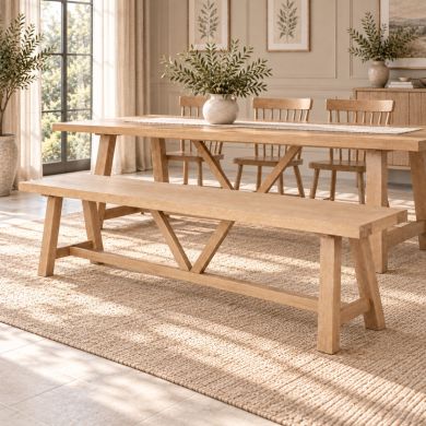Doveridge 220cm whitewash limed oak large trestle dining bench with central V supports in an elegant panelled dining room