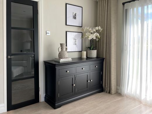 Toulouse 140cm black painted large assembled sideboard with three drawers and three cupboard doors in a contemporary living room