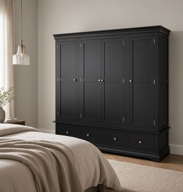 Deep black painted Toulouse 4-door quad extra-large wardrobe with drawers, shown in a stylish neutral bedroom interior