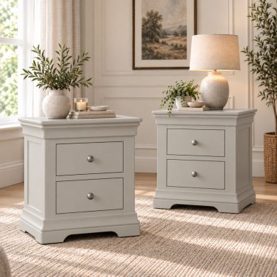 Pair of Toulouse Grey painted 2 drawer bedside tables with chrome knobs in a bright bedroom setting
