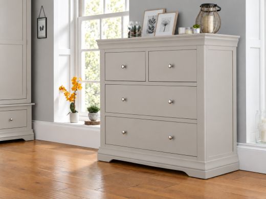 Toulouse Grey Grande 2 over 2 chest of drawers with chrome knobs, styled with botanical prints and a woven lantern beside sash windows
