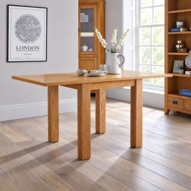 Lichfield oak flip-top extending dining table, extending from 80cm square to 160cm, shown fully extended in a bright dining room