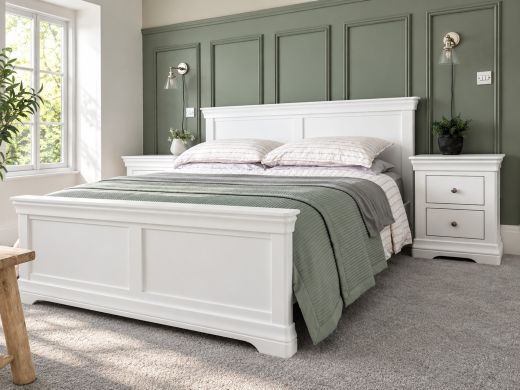 Toulouse brilliant white painted 5ft king size bed with sage green bedding in a bedroom with green wall panelling and matching white bedside tables