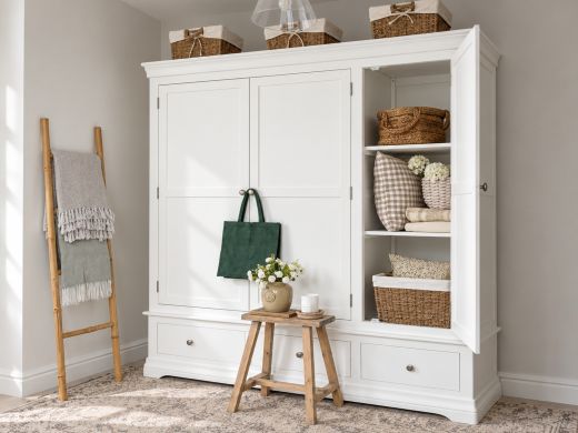 Toulouse brilliant white painted triple wardrobe with right door open in a neutral bedroom