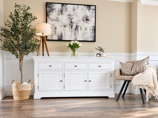 Toulouse 160cm white painted sideboard with three drawers and three doors in a neutral living room