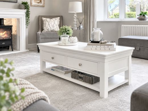 Toulouse white painted large coffee table with four drawers, chrome knobs and a lower shelf in a neutral living room