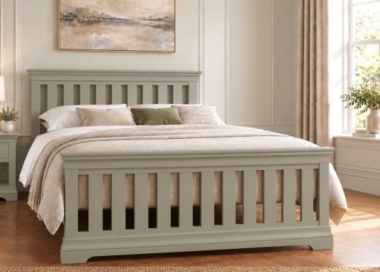 Grey painted slatted bed in an elegant neutral bedroom with soft cream bedding and warm natural light.