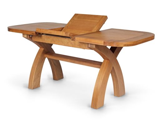 Country Oak cross-leg extending dining table with the butterfly leaf raised between the separated tabletop halves