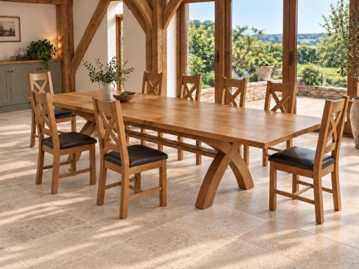 Country Oak 340cm cross leg extending dining table with eight oak cross back chairs in a sunlit oak-beamed dining room