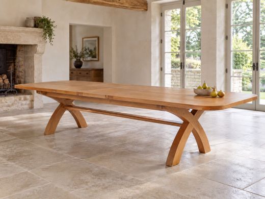 Country Oak dining table fully extended to 340 cm, with rounded corners and curved cross legs, in a bright country-house dining room