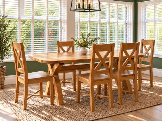 Country Oak 180cm cross-leg dining table with rounded corners and two oak benches, styled with flowers in a warm mustard dining room