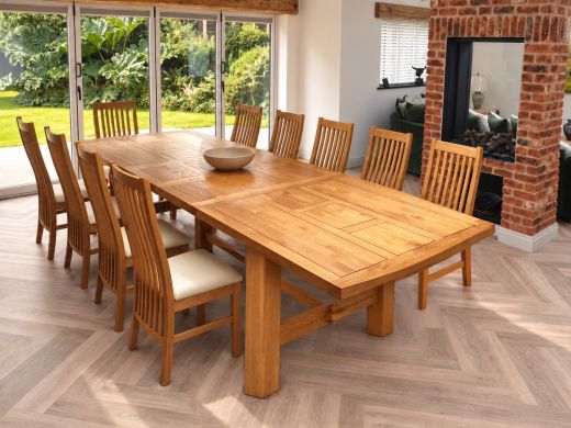 Chunky Chateaux large extending solid oak dining table with cream-seat oak chairs in a bright garden room