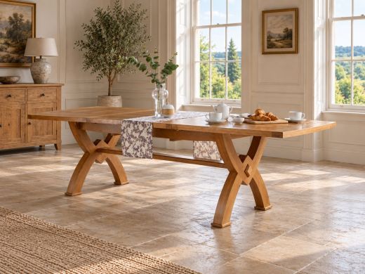 Monastery solid oak cross-leg extending dining table fully extended to 300 cm, styled for breakfast in a country dining room with sash windows and a stone floor