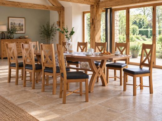 Monastery solid oak extending dining table with cross-back chairs in an oak-beamed country dining room