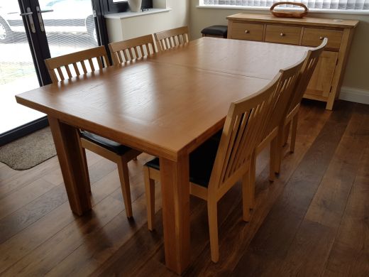 Customer photo 1 - Country oak 280cm large double extending dining table in a customers dining room next to a sideboard.